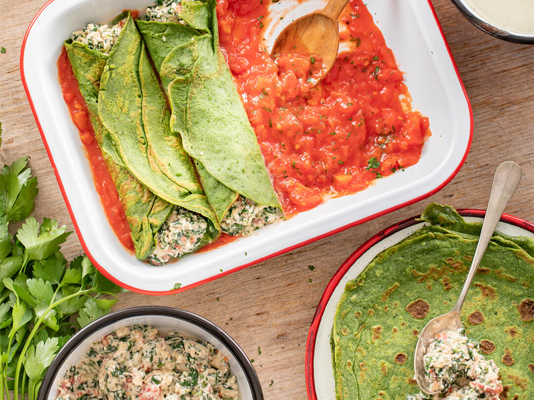 Canelones rellenos de ricotta, jamón, queso y tomates cubeteados gratinados con crema de leche y salsa pomarola